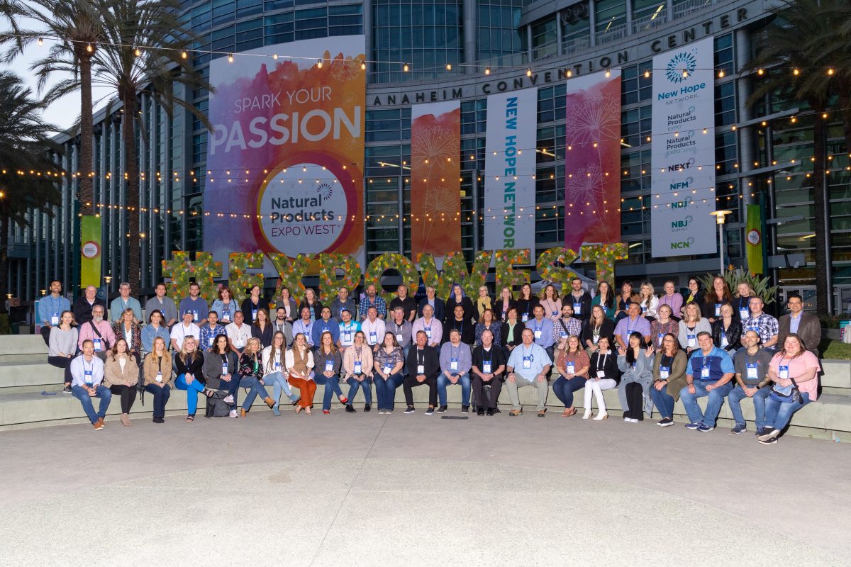 Group of people posing outside conference venue